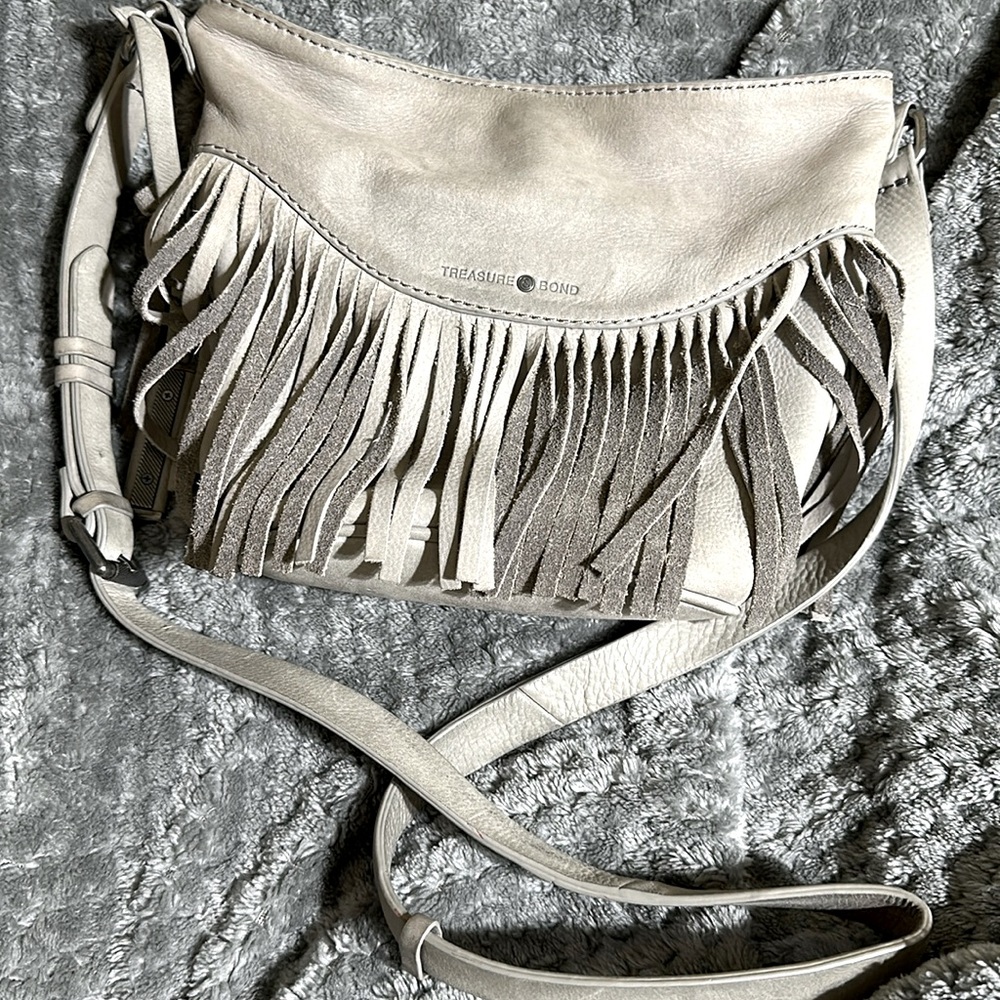 Beautiful grey suede fringe purse. It’s perfect for your daily essentials.